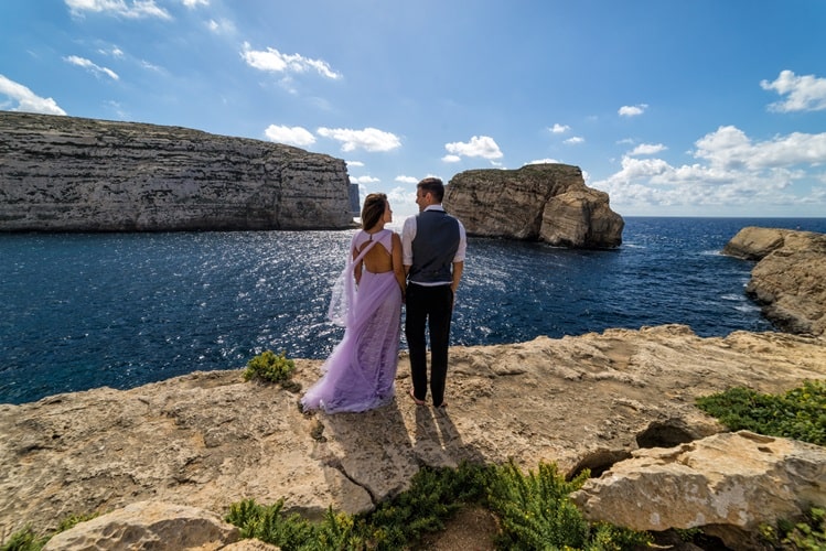 Couple getting married on the rugged Maltese coastline. Island of Gozo Malta min